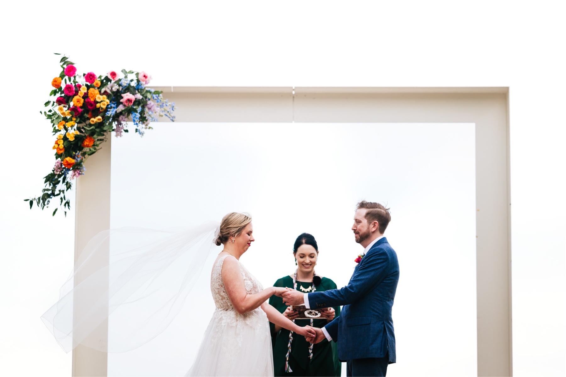 Bride and groom holding hands during their ceremony at Prospect House Austin TX wedding.