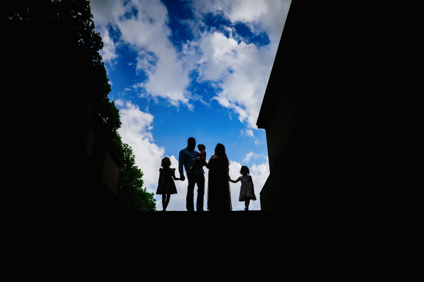 The Hull family silhouetted against a beautiful blue sky on the steps outside the capitol in Charleston, WV.