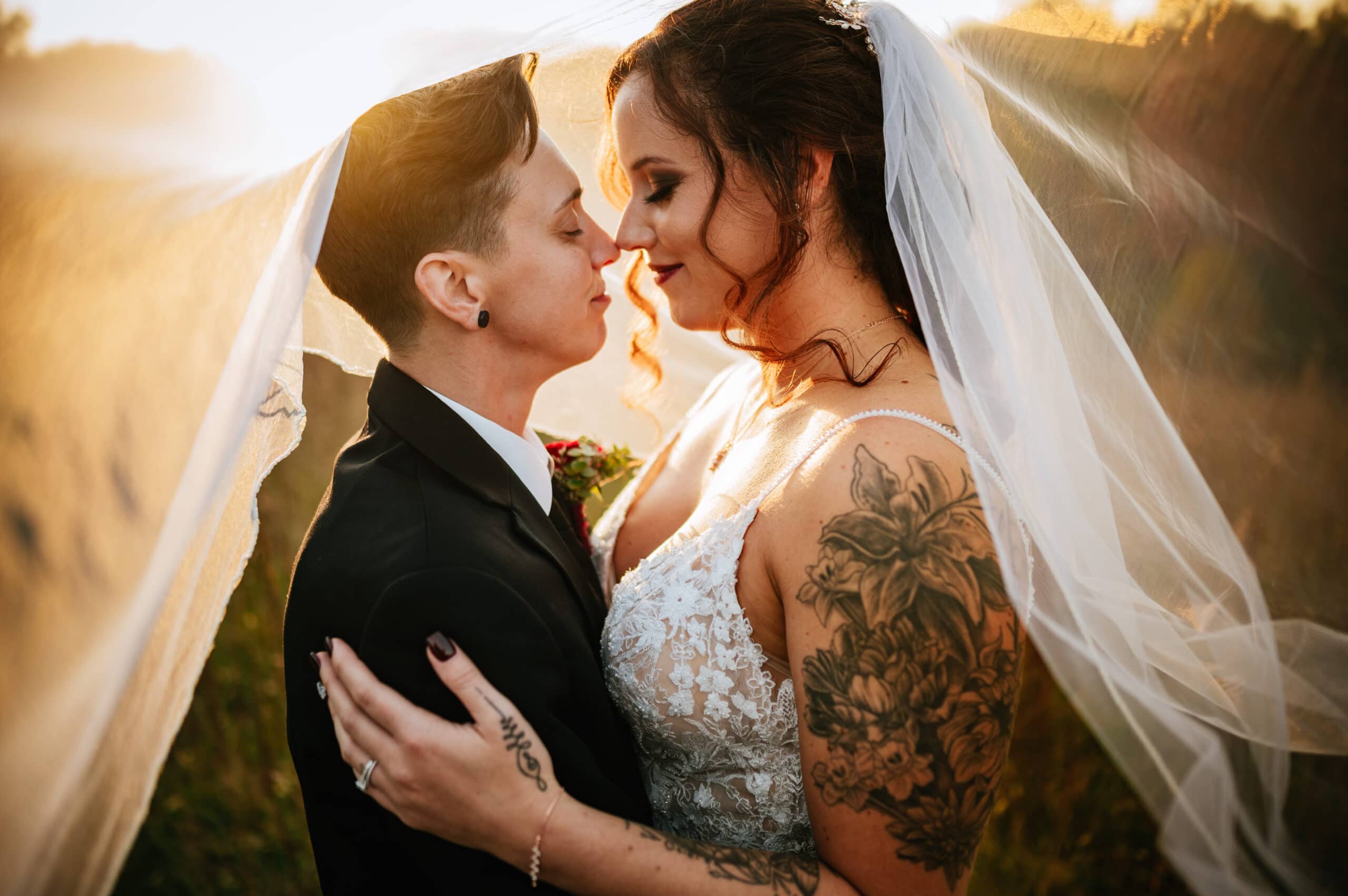 lgbtq gay west virginia brides embrace under veil 