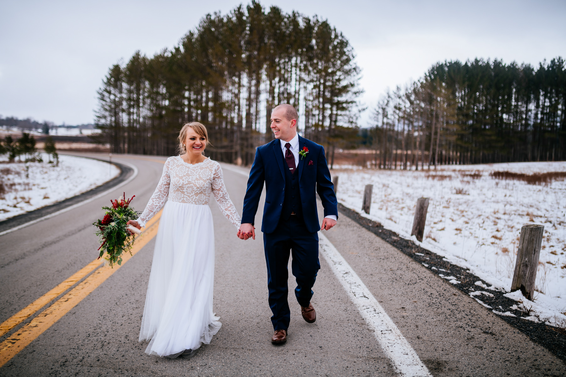 bride and groom walking down road