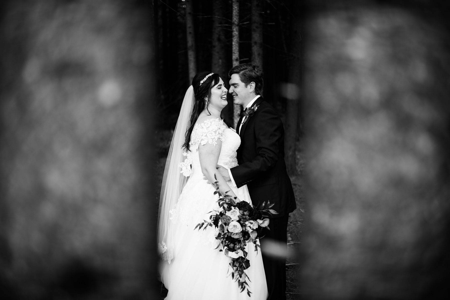 black and white bride and groom portrait in forest