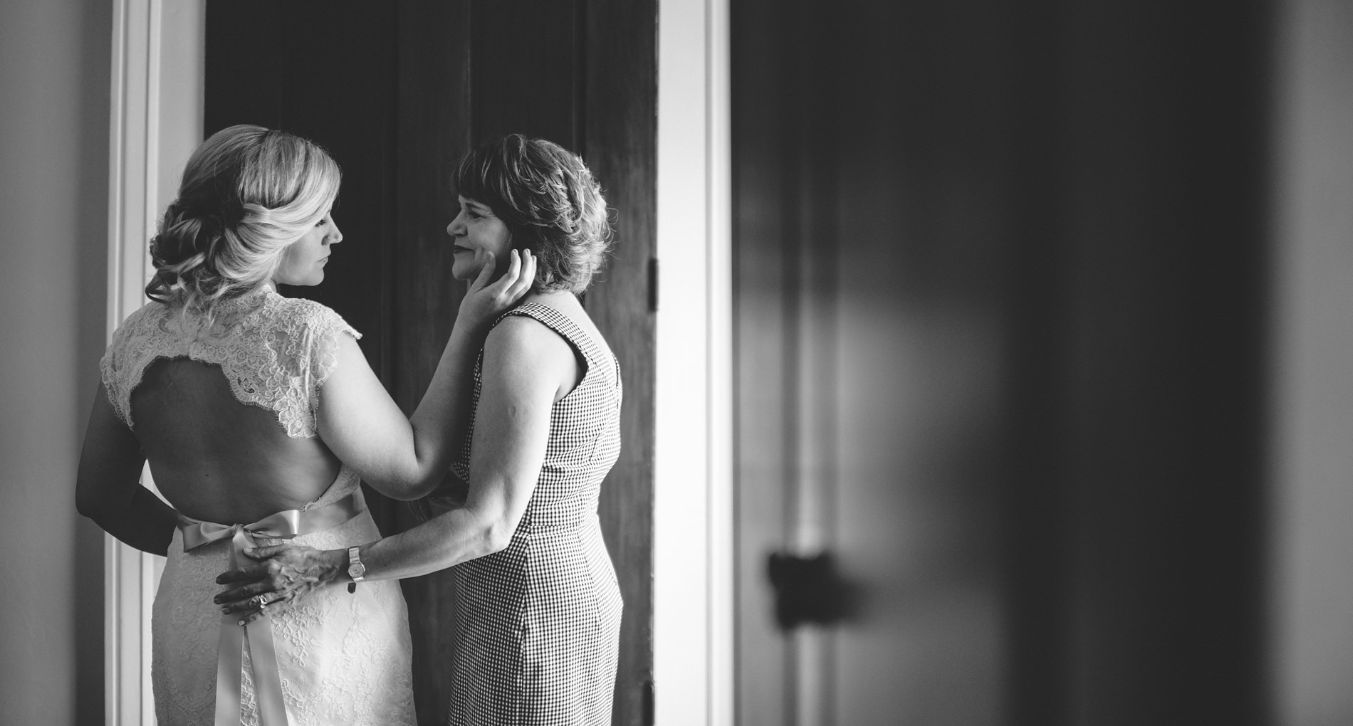 tender moment between mother and her daughter on wedding day