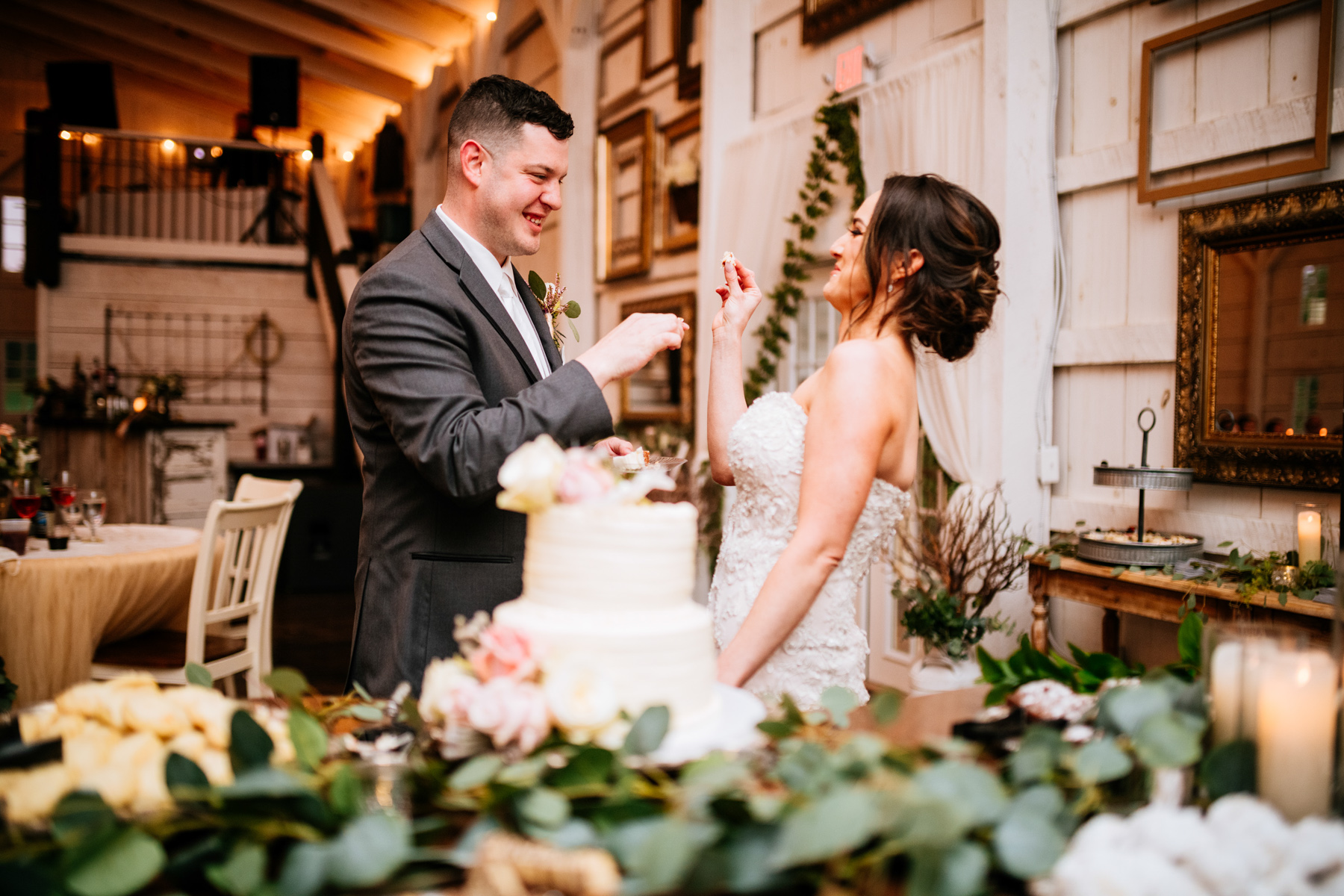 groom feeds bride cake
